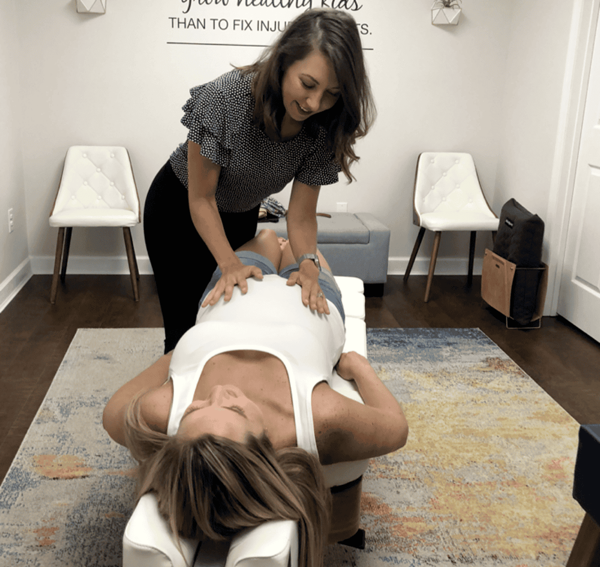 Dr. Kasandra Ruettiger providing a gentle prenatal chiropractic adjustment at Charleston Chiropractic Studio in Charleston, SC
